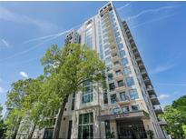 Modern condo building featuring balconies and large windows, surrounded by mature trees at 2520 Peachtree Rd # 602, Atlanta, GA 30305