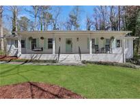 Charming white brick ranch home with a welcoming front porch and well-manicured lawn at 1342 Bertha Way, Marietta, GA 30062