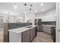 Modern kitchen with stainless steel appliances, gray cabinets and quartz countertops at 1955 Nocturne Dr # 3301, Alpharetta, GA 30009