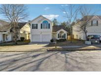 Charming two-story home featuring a well-manicured lawn and a two-car garage at 2722 S Hills S, Riverdale, GA 30296