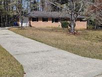 Charming one-story brick home with a well-manicured lawn and long driveway at 3685 Emily Way, Atlanta, GA 30349