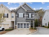 Charming two-story townhome with gray siding, black shutters, and a two-car garage at 5726 Taylor Way, Sandy Springs, GA 30342