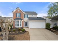 Charming two-story home featuring a two-car garage, bay window and classic brick accents at 331 Greystone Pkwy, Hiram, GA 30141