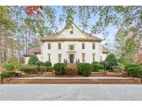 Stunning two-story home with brick exterior, manicured landscaping, and a grand entrance, exuding curb appeal at 540 Saint James Pl, Marietta, GA 30064