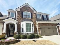 Charming two-story home featuring stone accents, a two-car garage and beautifully manicured landscaping at 2675 Sardis Chase Ct, Buford, GA 30519