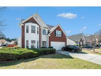 Charming two-story home with a well-maintained lawn and beautiful brick and white siding at 3287 Shady Valley Ln, Loganville, GA 30052