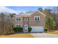 Charming two-story brick home with well-maintained landscaping and an attached two-car garage at 2160 Liberty Hts, Fairburn, GA 30213