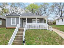 Charming gray home featuring a covered front porch and a welcoming entrance at 652 Hugh Sw St, Atlanta, GA 30310