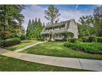 Charming home featuring a well-manicured lawn and lush landscaping at 1658 East Clifton Rd, Atlanta, GA 30307