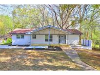 Charming brick home with a cozy front porch and newly landscaped front yard at 2248 Doris Dr, Decatur, GA 30034