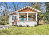 Charming bungalow with a welcoming front porch, wood detail, and manicured lawn at 3197 Church St, Atlanta, GA 30344