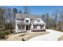 Charming two-story home with a manicured lawn and elegant landscaping, situated on a spacious lot with mature trees at 4383 Capstone Court, Roswell, GA 30075