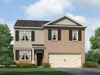 Charming two-story home featuring brick accents, complementary siding, and a two-car garage at 8227 Coldstream Dr, Fairburn, GA 30213