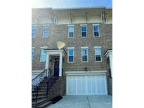 Charming brick townhome with a two car garage and classic architectural details at 1194 John Collier Rd, Atlanta, GA 30318