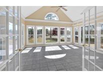 Bright sunroom with large windows offering scenic views of the surrounding landscape and lake, providing ample natural light at 2445 Ridgelake Dr, Villa Rica, GA 30180