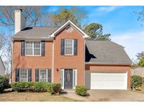 Charming two-story brick home with black shutters, a two-car garage and a manicured front yard at 4342 Richmond Nw Pl, Acworth, GA 30101