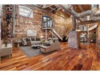 Spacious industrial-style living room with exposed brick, ductwork, and an open floor plan at 490 Marietta Nw St # 105, Atlanta, GA 30313