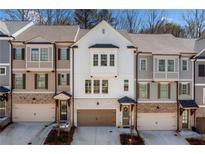 Beautiful three-story townhomes with brick accents and attached garages at 234 Retreat Ln, Canton, GA 30114