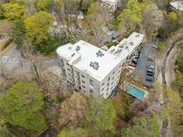 An aerial view shows the condo building with a community pool and surrounding green space at 140 Alden Nw Ave # 201, Atlanta, GA 30309