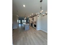 An open-concept kitchen and dining area with stainless appliances and a large kitchen island at 1979 Deco Dr, Kennesaw, GA 30144