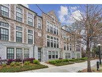 Brick townhome featuring black trim windows and manicured landscaping at 269 Devin Ne Pl, Atlanta, GA 30305