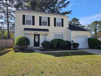 Inviting two-story home features a well-manicured front yard and a classic design with black shutters at 6406 Laurel Post Dr, Lithonia, GA 30058