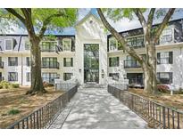 Charming condo building with lush landscaping and elegant entry, exuding curb appeal and inviting ambiance at 2303 Pine Heights Ne Dr, Atlanta, GA 30324