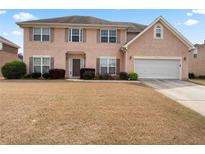 Charming two-story home featuring a two-car garage and well-maintained landscaping at 765 Rock Ln, Mcdonough, GA 30253