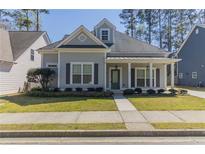 Charming one-story home featuring a welcoming front porch and well-maintained lawn at 405 Rabbits Run, Fayetteville, GA 30214