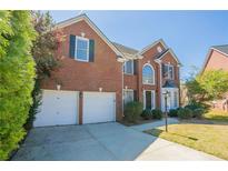 Charming brick two-story home with attached two-car garage and well-maintained landscaping at 1602 Allsworth Se Ct, Smyrna, GA 30082