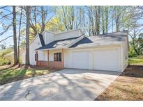 Charming home with a two-car garage and a cozy front porch at 2991 Owens Meadow Nw Dr, Kennesaw, GA 30152