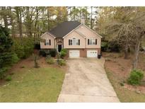 Two-story home featuring a two-car garage and a traditional facade at 2425 River Place Xing, Douglasville, GA 30135