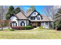 Beautiful two-story home featuring manicured lawn, tasteful landscaping and traditional design elements at 4852 Jacobs Cove Pt, Buford, GA 30519