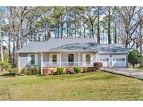 Charming single-story home with a well-manicured lawn and attached two car garage at 8698 Twin Oaks Dr, Jonesboro, GA 30236