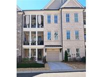 Charming townhome with brick facade, two-car garage, and inviting covered balconies at 227 Atley Pl, Alpharetta, GA 30009