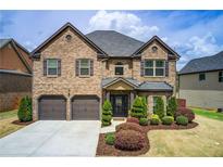 Beautiful two-story brick home with a well-manicured lawn and attached two-car garage at 2580 Brittany Park Cv, Ellenwood, GA 30294