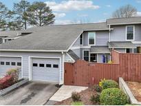 Charming townhome with a garage and a cozy fenced front yard with well-maintained landscaping at 4988 Meadow Ln, Marietta, GA 30068