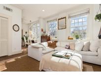 Bright living room boasts a comfortable white sectional couch and plenty of natural light at 1 S Prado Ne # 15, Atlanta, GA 30309