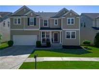 Charming two-story home featuring well-maintained lawn and attached two-car garage, offering curb appeal and convenience at 1218 Lanier Springs Dr, Buford, GA 30518
