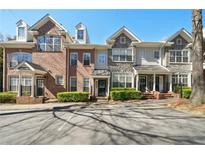 Beautiful townhome exteriors with brick and stone accents and manicured landscaping at 1119 Glenridge Pl, Atlanta, GA 30342