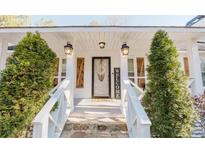 Inviting front porch with stone walkway, fresh landscaping, and a welcoming entrance at 511 Laird Rd, Hiram, GA 30141