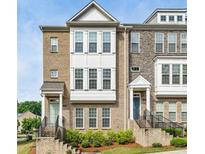 Charming townhome with brick and stone facade, featuring a well-maintained lawn and inviting entrances at 1165 Millennium Park Rd, Decatur, GA 30033