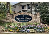 Wynne's Ridge community sign surrounded by colorful tulips and greenery, welcoming residents and guests at 1501 Wynnes Ridge Cir, Marietta, GA 30067