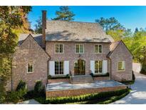 Stunning brick home with a well-manicured lawn and mature trees, creating a timeless curb appeal at 2515 Habersham Rd, Atlanta, GA 30305