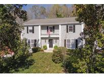 Two-story home featuring a balcony, shutters, and a manicured front yard at 60 Brandon Ridge Dr, Sandy Springs, GA 30328