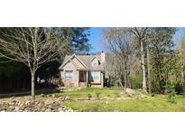 Charming brick home with landscaped front yard and inviting entrance surrounded by a lush, natural setting at 120 Johnson Nw Rd, Atlanta, GA 30318