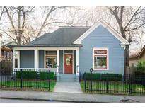 Charming home featuring a symmetrical facade, blue siding, red door and window trim, plus mature landscaping at 84 Chester Se Ave, Atlanta, GA 30316