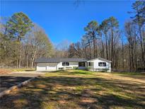 Charming ranch-style home with a two-car garage and well-maintained lawn at 621 Hood Rd, Stockbridge, GA 30281