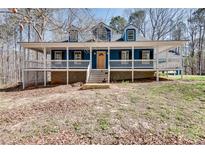 Charming blue home with a welcoming front porch and classic architectural details at 2970 Oxford Rd, Atlanta, GA 30349