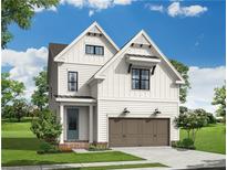 New two-story home boasts white siding, a two car garage and inviting entrance at 630 Silva St, Cumming, GA 30040